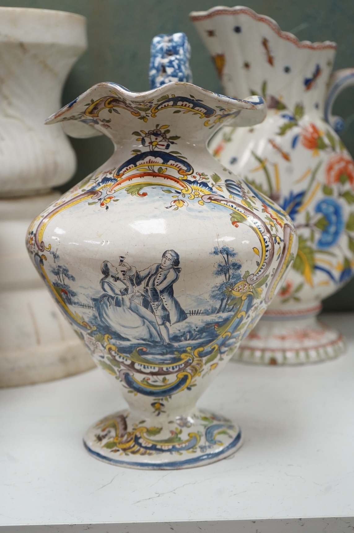 Two large French faience jugs and a vase, and a Talavera twin handled urn/vase, 44cm high